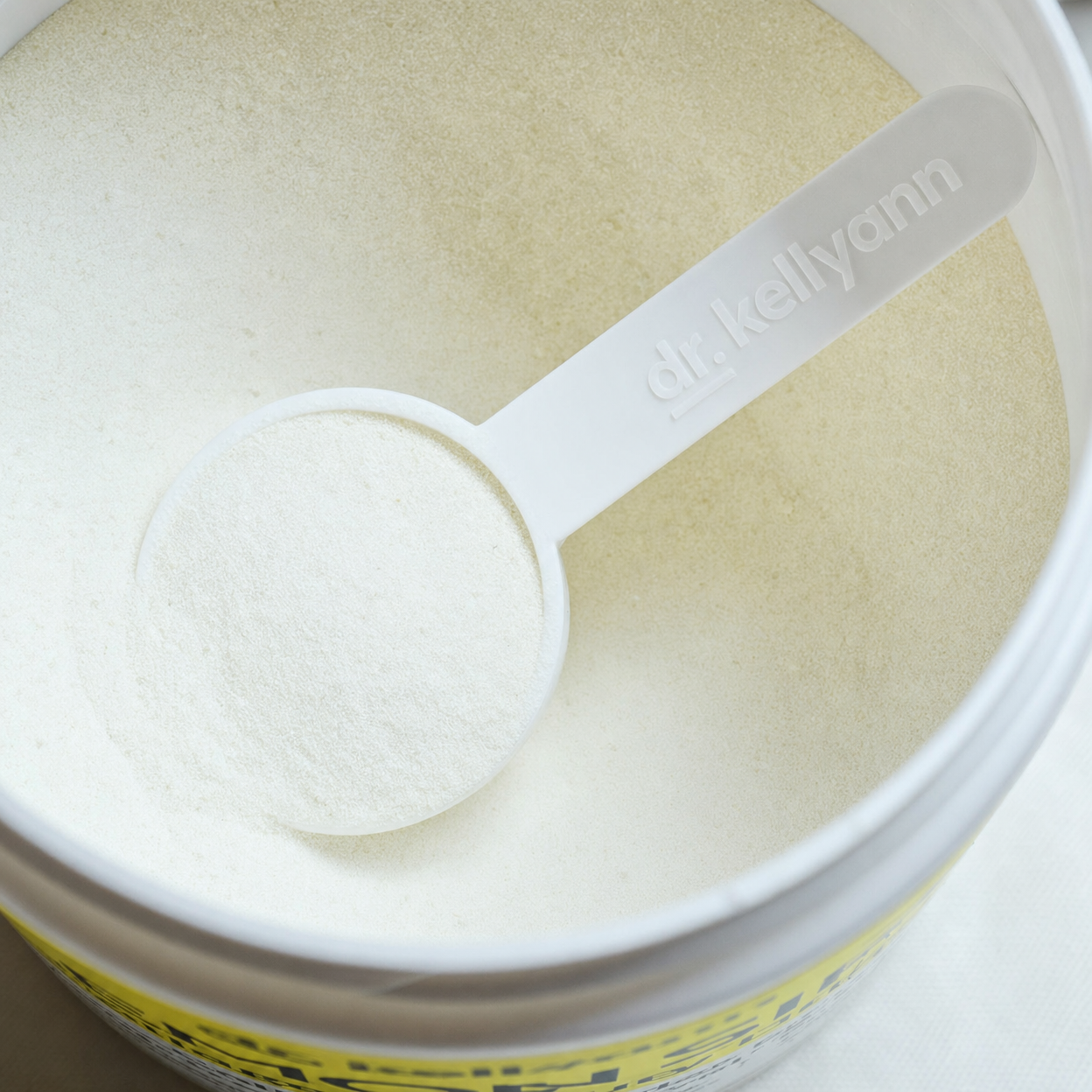 Dr. Kellyann Lemon Sips collagen powder with branded measuring scoop